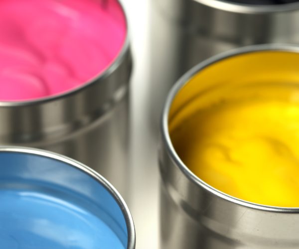 CMKY paint cans close up